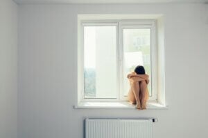 depressive moods rehabilitation treatment sad woman hug her knee and cry on window