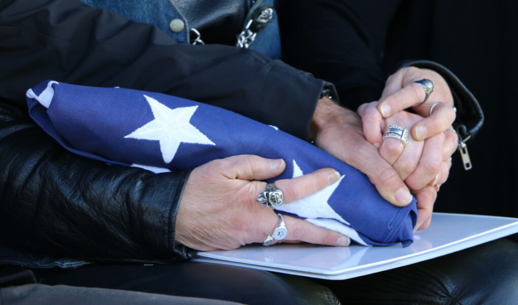 how to deal grieving and grief holding hands and folded american flag given them at their fathers funeral sad death