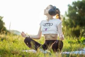 mindfulness girl headphones meditating yoga meditation radio audiobook female adult attractive grass young relaxing how to start