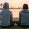 Young adult watching sunrise over Mission Bay representing hope in depression and substance use recovery