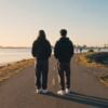 Two young adults choosing between two Mission Bay paths at morning symbolizing PHP vs IOP levels of care