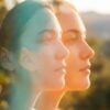 Double-exposure portrait symbolizing dual diagnosis, with overlapping profiles in teal and orange light
